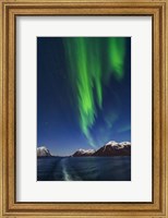 Framed Aurora Over Moonlit Peaks in the Norwegian Sea