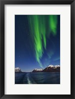 Framed Aurora Over Moonlit Peaks in the Norwegian Sea