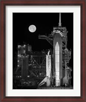Framed Space Shuttle Discovery Sits Atop the Launch Pad With a Full Moon in Background