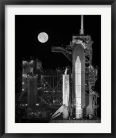 Framed Space Shuttle Discovery Sits Atop the Launch Pad With a Full Moon in Background