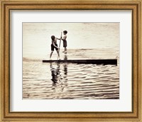 Framed Two boys standing on a wooden platform in a lake