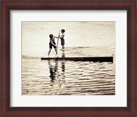 Framed Two boys standing on a wooden platform in a lake
