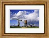 Framed Low angle view of a water tower and an industrial windmill, 1880 Town, South Dakota, USA