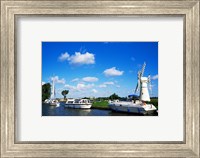 Framed Boats moored near a traditional windmill, River Thurne, Norfolk Broads, Norfolk, England