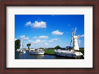 Framed Boats moored near a traditional windmill, River Thurne, Norfolk Broads, Norfolk, England