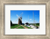 Framed Boat moored near a traditional windmill, River Ant, Norfolk Broads, Norfolk, England
