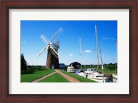 Framed Boat moored near a traditional windmill, River Ant, Norfolk Broads, Norfolk, England