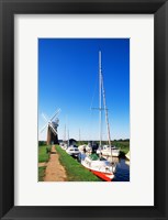 Framed Boats moored near a traditional windmill, Horsey Windpump, Horsey, Norfolk Broads, Norfolk, England