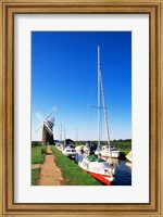 Framed Boats moored near a traditional windmill, Horsey Windpump, Horsey, Norfolk Broads, Norfolk, England