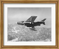 Framed Side profile of a fighter plane carrying sidewinder missiles during flight, F9F-8 Cougar, US Navy