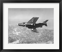 Framed Side profile of a fighter plane carrying sidewinder missiles during flight, F9F-8 Cougar, US Navy
