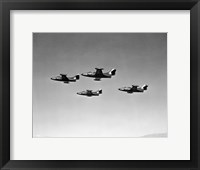Framed Low angle view of four fighter planes flying in formation, F9F Panther