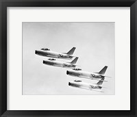 Framed Four military planes flying in a formation