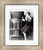 Framed Young woman sitting beside an RCA Radio-Phonograph and Home Recorder