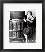 Framed Young woman sitting beside an RCA Radio-Phonograph and Home Recorder