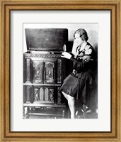 Framed Young woman sitting beside an RCA Radio-Phonograph and Home Recorder