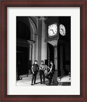 Framed Young men standing below clock at night