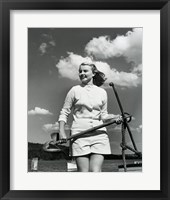 Framed Young woman standing on boat, holding anchor