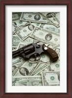 Framed Close-up of a handgun with paper currency