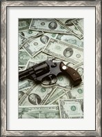 Framed Close-up of a handgun with paper currency