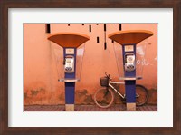 Framed Public telephone booths in front of a wall, Morocco