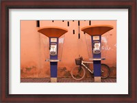 Framed Public telephone booths in front of a wall, Morocco