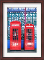 Framed Two telephone booths near a grille, London, England