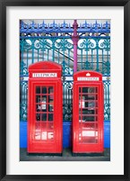 Framed Two telephone booths near a grille, London, England
