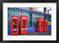 Framed Four telephone booths near a grille, London, England