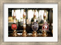 Framed Close-up of beer tap handles in a bar, London, England