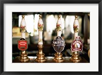 Framed Close-up of beer tap handles in a bar, London, England