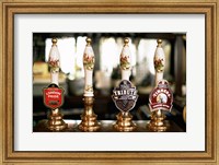 Framed Close-up of beer tap handles in a bar, London, England