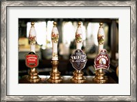 Framed Close-up of beer tap handles in a bar, London, England