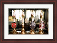 Framed Close-up of beer tap handles in a bar, London, England