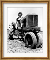 Framed Farmer Sitting on a Tractor in a Field