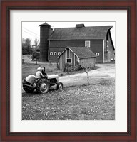 Framed Man with a Boy Riding a Tractor in a Field
