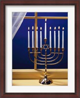 Framed Close-up of burning candles on a menorah at a window