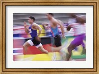 Framed Side profile of three men running on a running track
