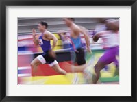 Framed Side profile of three men running on a running track