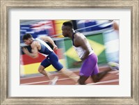 Framed Side profile of two young men running on a running track