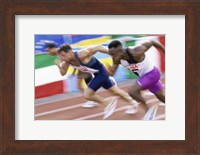 Framed Side profile of three men running low on a running track