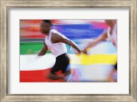 Framed Side profile of two young men passing a relay baton