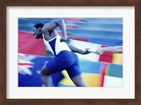 Framed Side profile of runners passing a baton in a relay race