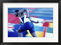 Framed Side profile of runners passing a baton in a relay race