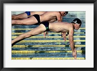 Framed Side profile of three swimmers jumping into a swimming pool