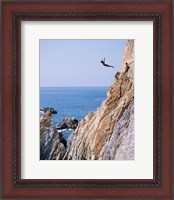 Framed Male cliff diver jumping off a cliff, La Quebrada, Acapulco, Mexico