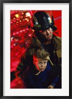 Framed Close-up of a firefighter carrying a boy