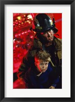 Framed Close-up of a firefighter carrying a boy