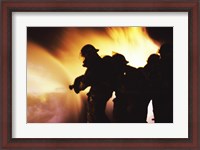 Framed Firefighters Extinguishing A Fire With Water
