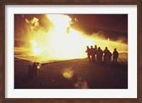 Framed High angle view of firefighters extinguishing a fire